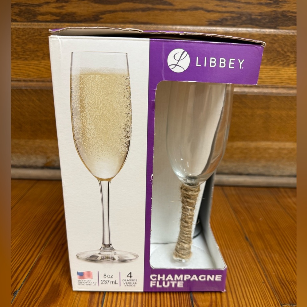 4 Champagne Flutes that we DIYed for our wedding by adding jute twine with glue.